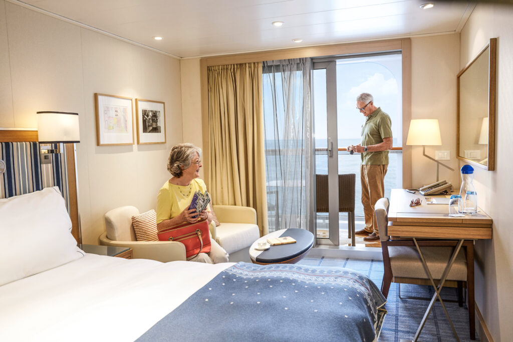 Couple relaxing in a Deluxe Veranda Stateroom aboard the Viking Star