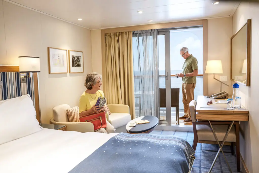 Couple relaxing in a Deluxe Veranda Stateroom aboard the Viking Star