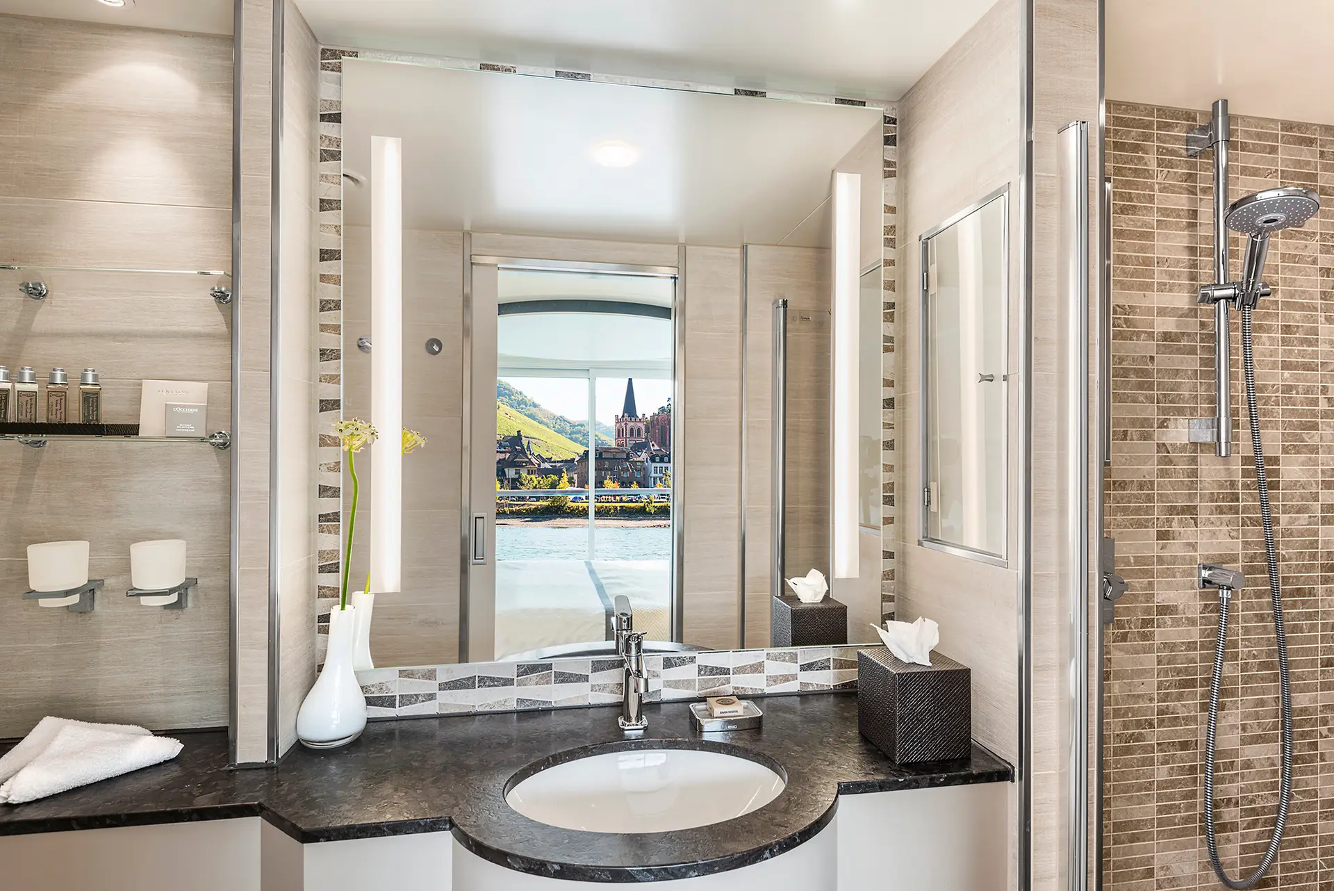 Bathroom in the Veranda Suite onboard the Viking Longship Hlin with the town of Bachrach in the Upper Middle Rhine Valley reflected in the mirror.